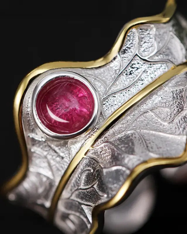 Gros plan sur la bague feuille en argent 925 montrant la texture organique du métal et la pierre naturelle tourmaline rose.