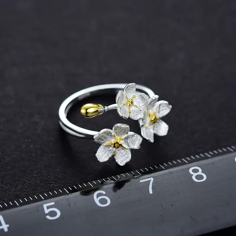 Bague trois fleurs ajustable en argent 925 avec indication de taille, vue e-commerce précise.